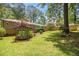 Large backyard with a lush lawn, storage shed, water garden, and a glimpse of the home's exterior at 4352 Treeline Way, Douglasville, GA 30135