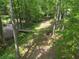 Overhead view of the wooded backyard with a stream and bridge, offering privacy and a natural setting at 4352 Treeline Way, Douglasville, GA 30135