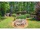 Serene backyard with lush greenery, shed, water feature, and covered patio, offering a tranquil outdoor escape at 4352 Treeline Way, Douglasville, GA 30135