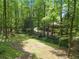 Spacious wooded backyard featuring a stream, footbridge, and mature trees, offering a natural and private retreat at 4352 Treeline Way, Douglasville, GA 30135