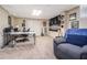 Versatile finished basement with neutral walls and carpet, a home office space, and a cozy entertainment area at 4352 Treeline Way, Douglasville, GA 30135