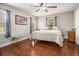 Bedroom with hardwood floors, a ceiling fan, and a comfortable bed with a patterned comforter and lots of light at 4352 Treeline Way, Douglasville, GA 30135