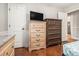 Bedroom featuring classic wooden dressers and drawers, hardwood floors, and paneled walls for added charm at 4352 Treeline Way, Douglasville, GA 30135