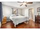 Bedroom featuring hardwood floors, a ceiling fan, and a comfortable bed with a patterned comforter and lots of light at 4352 Treeline Way, Douglasville, GA 30135