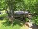 Secluded home exterior with lush green trees and driveway leading to carport at 4352 Treeline Way, Douglasville, GA 30135