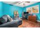 Bright home office with blue walls, hardwood floors, and a comfortable workspace with ample natural light at 4352 Treeline Way, Douglasville, GA 30135