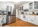 Well-lit kitchen with stainless steel refrigerator and white cabinets, offering ample storage at 4352 Treeline Way, Douglasville, GA 30135