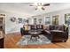 Comfortable living room featuring hardwood floors, a ceiling fan, and bright natural light at 4352 Treeline Way, Douglasville, GA 30135