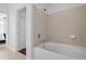 Bathroom featuring a white tiled shower over tub with chrome fixtures and linen colored walls at 10 Perimeter Summit Ne Blvd # 4243, Brookhaven, GA 30319