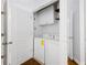 A bright laundry room featuring a washer and dryer, complemented by convenient overhead storage cabinets at 10 Perimeter Summit Ne Blvd # 4243, Brookhaven, GA 30319