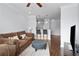 Cozy living room featuring a comfortable sofa, hardwood floors, and an open layout with kitchen access at 10 Perimeter Summit Ne Blvd # 4243, Brookhaven, GA 30319