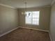 Dining room featuring carpeted floors, neutral paint, and a chandelier at 1012 Riverclift Dr, Covington, GA 30016