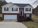 Two-story home featuring a brick facade, brown shutters, and a two-car garage at 1012 Riverclift Dr, Covington, GA 30016