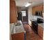 Kitchen boasts stainless steel appliances, wood cabinets, and granite countertops at 1012 Riverclift Dr, Covington, GA 30016