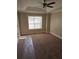 Main bedroom featuring carpeted floors, neutral paint, ceiling fan and a large window at 1012 Riverclift Dr, Covington, GA 30016
