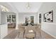 Elegant dining room with modern lighting, stylish furniture, and large windows at 1462 Devon Mill Way, Austell, GA 30168