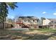 View of the back exterior with access stairs and deck at 1462 Devon Mill Way, Austell, GA 30168