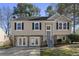 Charming home featuring stone accents, neutral siding, black shutters and a well-maintained front lawn at 1462 Devon Mill Way, Austell, GA 30168