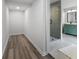 Bathroom including a glass-enclosed shower, tile flooring, and storage space at 1870 Avon Sw Ave, Atlanta, GA 30311