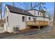 Charming home exterior featuring a freshly painted white brick, black trim, and wooden deck at 1870 Avon Sw Ave, Atlanta, GA 30311