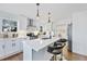 Contemporary kitchen with stainless steel appliances, quartz countertops, and stylish bar seating at 1870 Avon Sw Ave, Atlanta, GA 30311