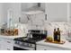 Modern kitchen features stainless steel appliances, white cabinets, and marble backsplash at 1870 Avon Sw Ave, Atlanta, GA 30311