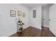 Clean laundry room with decorative accents, hardwood flooring, and white walls at 1870 Avon Sw Ave, Atlanta, GA 30311