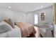 Comfortable main bedroom with stylish chairs, hardwood floors, and ample natural light at 1870 Avon Sw Ave, Atlanta, GA 30311