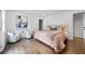 Cozy main bedroom with a neutral palette, plush bedding, and hardwood floors at 1870 Avon Sw Ave, Atlanta, GA 30311