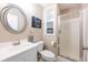 Elegant bathroom featuring a modern sink, toilet, decorative mirror, and glass-enclosed shower at 2330 Ivey Oaks Rd, Cumming, GA 30041