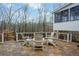 Outdoor deck featuring chairs, a table, and a view of the wooded surroundings at 2330 Ivey Oaks Rd, Cumming, GA 30041