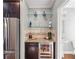 Elegant bar area with glass shelves, wine cooler, and granite countertop, adjacent to a half bath at 255 Southerland Ne Ter # 207, Atlanta, GA 30307