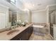 Luxurious bathroom with double sinks, soaking tub, and glass-enclosed shower at 255 Southerland Ne Ter # 207, Atlanta, GA 30307