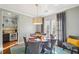 Charming dining area with round table, stylish chandelier, and elegant drapes at 255 Southerland Ne Ter # 207, Atlanta, GA 30307