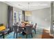 Cozy dining area with round table, place settings, and natural light from the windows at 255 Southerland Ne Ter # 207, Atlanta, GA 30307