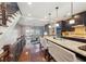 Open kitchen with granite island, dark wood cabinets, and seating, flowing into the living area at 255 Southerland Ne Ter # 207, Atlanta, GA 30307