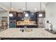 Bright kitchen featuring a large island with seating, stainless steel appliances, and dark wood cabinets at 255 Southerland Ne Ter # 207, Atlanta, GA 30307