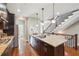 Stylish kitchen with a granite island, dark cabinetry, and stainless steel appliances, adjacent to stairs at 255 Southerland Ne Ter # 207, Atlanta, GA 30307