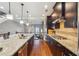 Open-concept kitchen with granite counters, dark wood cabinets, and stainless steel appliances, open to living area at 255 Southerland Ne Ter # 207, Atlanta, GA 30307