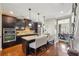 Modern kitchen featuring dark cabinets, stainless steel appliances, granite countertops, and an island with seating at 255 Southerland Ne Ter # 207, Atlanta, GA 30307