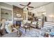 Bright living room featuring a stone fireplace, built-in shelving, and comfortable seating with a ceiling fan at 255 Southerland Ne Ter # 207, Atlanta, GA 30307