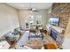 Open living area with a stone fireplace, ample seating, and natural light from large windows at 255 Southerland Ne Ter # 207, Atlanta, GA 30307