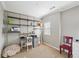 Office space with shelving, a desk, a red chair, and light gray walls, providing a modern aesthetic at 255 Southerland Ne Ter # 207, Atlanta, GA 30307