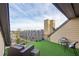 Outdoor patio with modern seating, table, and artificial turf offering a perfect space for relaxation at 255 Southerland Ne Ter # 207, Atlanta, GA 30307