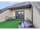 Outdoor patio area with furniture, artificial turf, and neutral colored siding offering a comfortable outdoor experience at 255 Southerland Ne Ter # 207, Atlanta, GA 30307