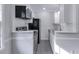 Cozy kitchen featuring white cabinets, stainless steel appliances, and tile backsplash at 86 De Arc Nw Pl, Atlanta, GA 30327