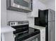 This kitchen has stainless steel appliances, white cabinets, and a tile backsplash at 86 De Arc Nw Pl, Atlanta, GA 30327