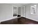 Living room with hardwood floors, a large window, and glass paneled doors to another room at 86 De Arc Nw Pl, Atlanta, GA 30327