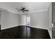 Open living room featuring dark wood floors, a ceiling fan, and a doorway to another room at 86 De Arc Nw Pl, Atlanta, GA 30327