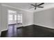 Bright living room with dark wood floors, a ceiling fan, and glass-paneled doors to another room at 86 De Arc Nw Pl, Atlanta, GA 30327